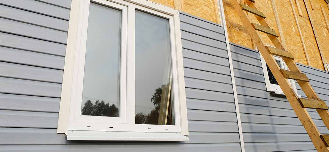 Grey siding on a house under construction.